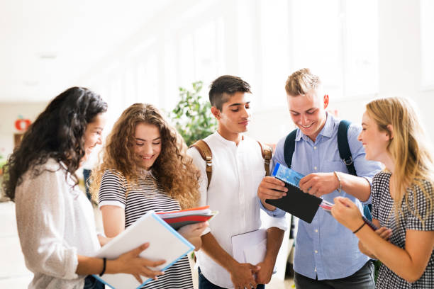 istock Teenage students walking in high school hall, talking. 846410770