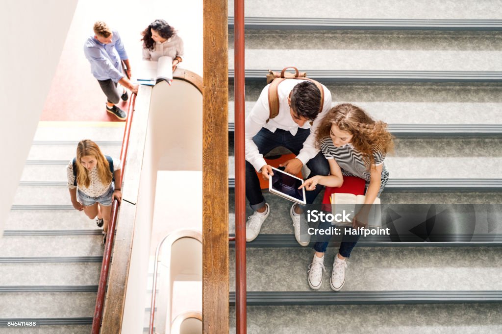 Studenti adolescenti sulle scale del liceo. - Foto stock royalty-free di Scalinata