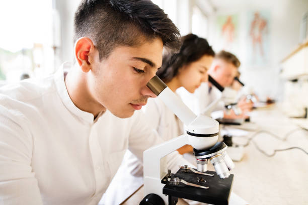 istock Beautiful high school students with microscopes in laboratory. 846411626