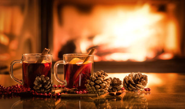 istock Mulled wine glasses on table in front of burning fireplace. 846414418
