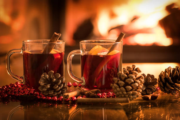 istock Mulled wine glasses on table in front of burning fireplace. 846414452