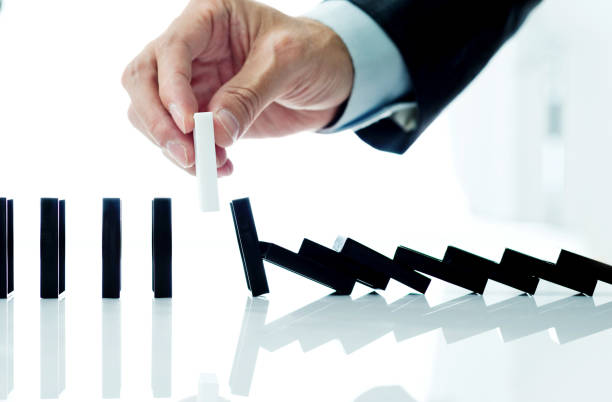 istock Businessman hand pick up one domino 846415462