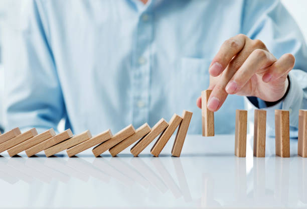 istock Businessman hand pick up one domino 846415752