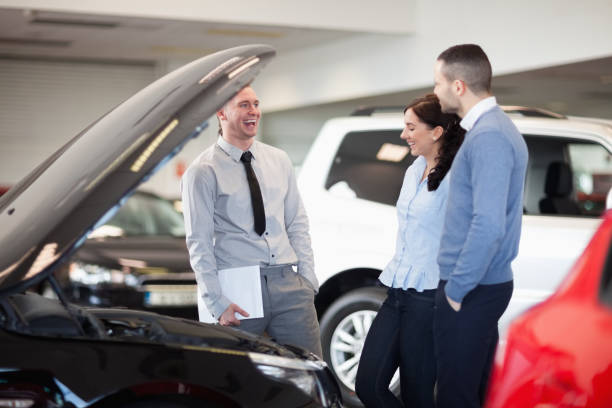 istock Salesman smiling as he talks to a couple 846415758