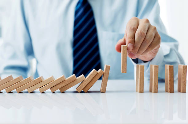 istock Businessman hand pick up one domino 846415810