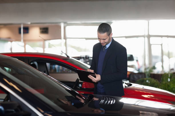 istock Man writing on a clipboard beside a car 846416038
