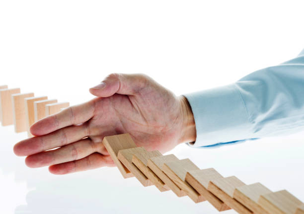istock Businessman hand stop domino effect 846418290