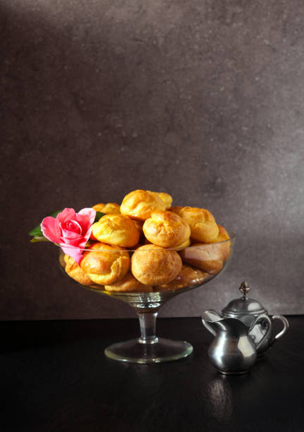 istock profiteroles and coffee Served in a vase for sweets and a rose 846419026