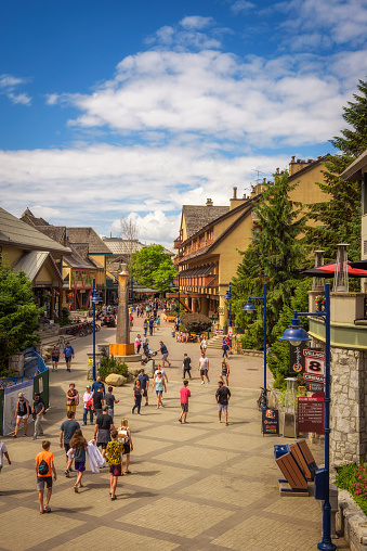 Whistler, British Columbia: Scenic street view with many tourists  in Whistler Village. Whistler is a canadian resort town visited by over 2 million people annually.