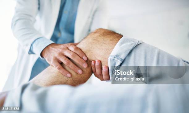 Senior Man Having Medical Exam Stock Photo - Download Image Now - Knee, Pain, Physical Therapy