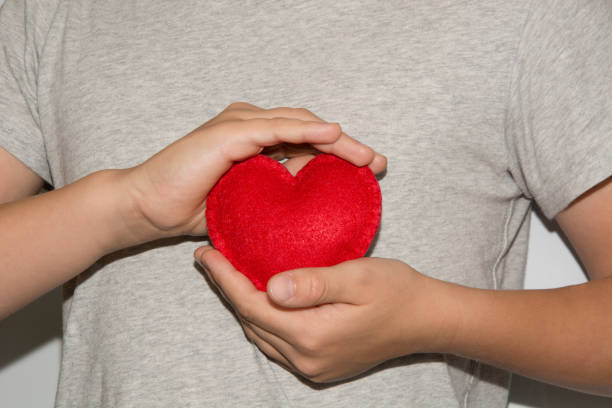 istock Young men hold red heart in hand. 846429380