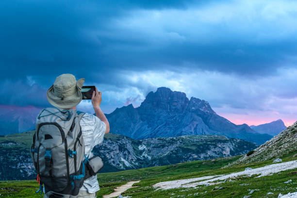 istock Man photographs the sunset over the mountains 846431092