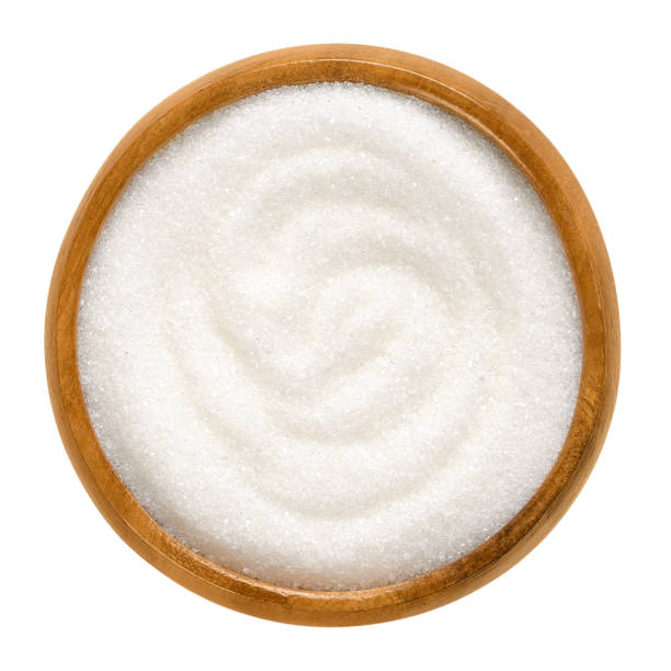 istock Fine granulated white sugar in wooden bowl over white 846436680