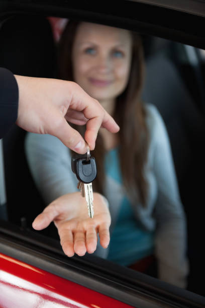 istock Dealer holding car keys by his fingertips 846440430