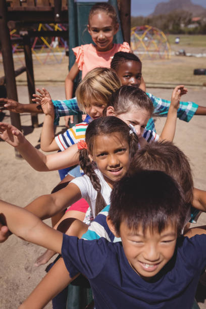 istock Happy schoolkids playing in playground 846443916