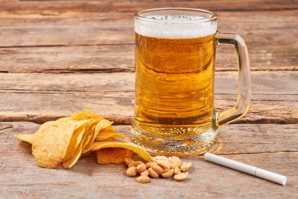 istock Glass of beer, chips, nuts, cigarette. 846444016
