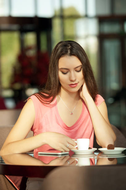 istock Girl with mobile phone in cafe 846447334