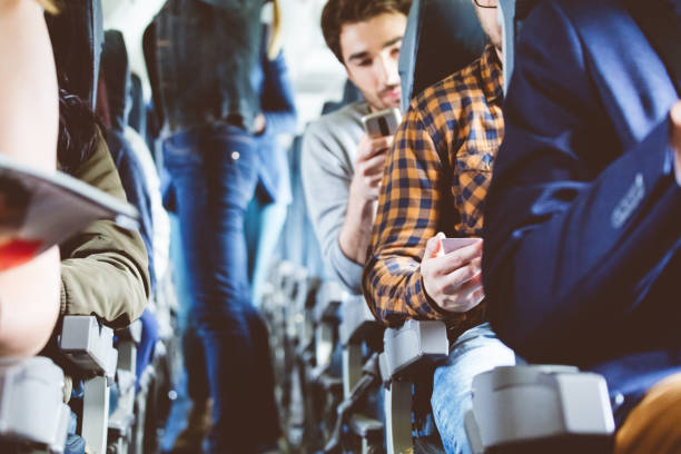 istock Airplane cabin with people using mobile phone 846458696