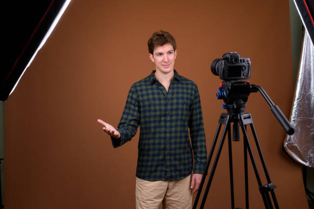 istock Studio shot of handsome businessman vlogging while wearing checkered shirt against colored background 846461886