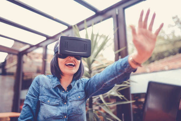 istock Young Woman Having Fun with Virtual Reality Simulator and Gesturing 846462694