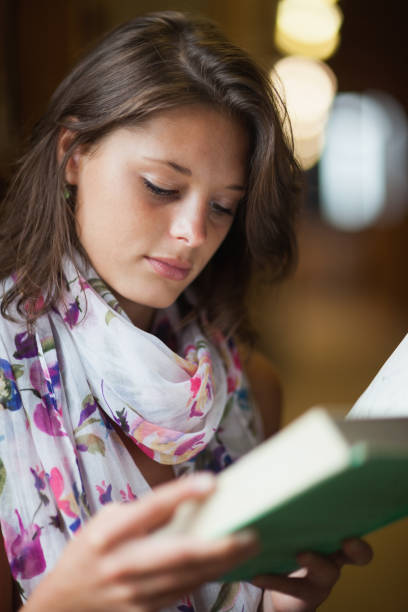 istock Close up of a beautiful female student reading a book 846465808