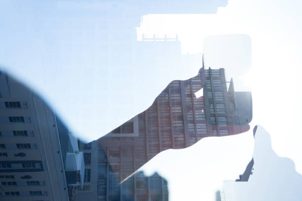 istock Businessman holding smart phone reflecting on window 846469382