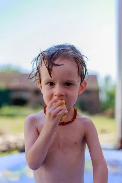 Male child plays in the swimming pool