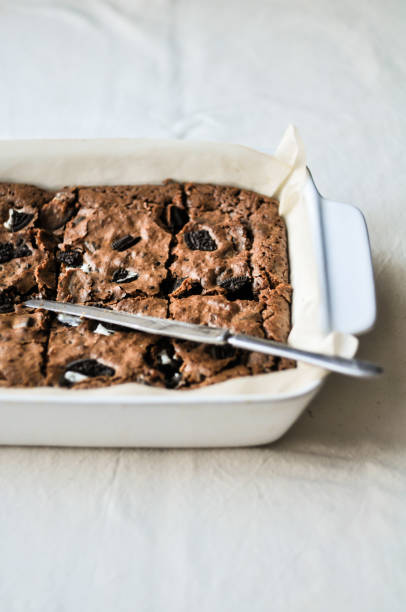istock Dark chocolate brownie squares with cookie on a white baking dish 846488898