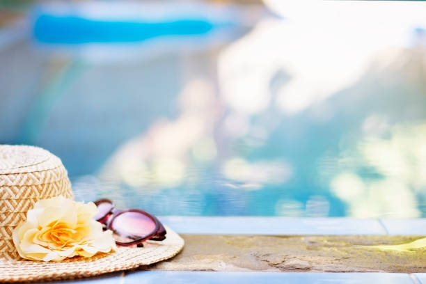 Summer accessories at the swim pool, hat with flower,  relax concept, Vacation time