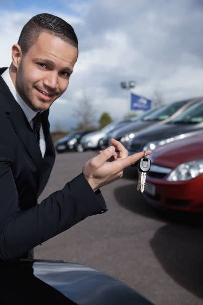 istock Man holding car keys with a finger 846489518