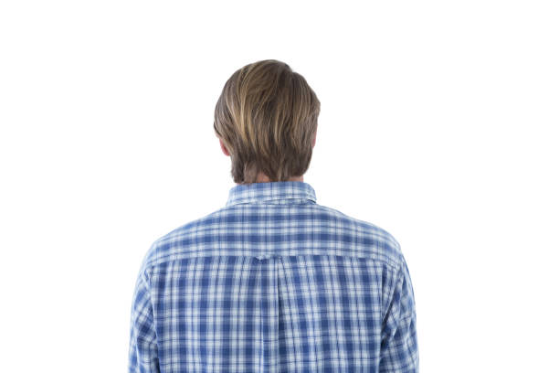 Rear view of businessman wearing checked pattern shirt against white background