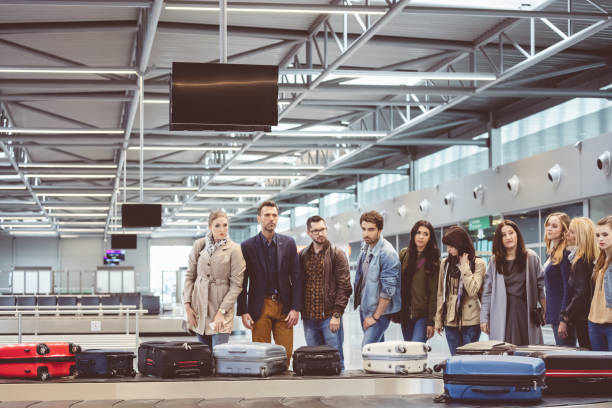 istock Travelers waiting for luggage at baggage claim area 846496148
