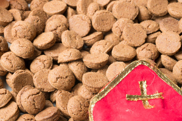 traditional dutch kruidnoten, spices biscuits, for special even Sinterklaas, close up, with red miter top view of Dutch and Belgian candy of holiday event in december mijter stock pictures, royalty-free photos & images