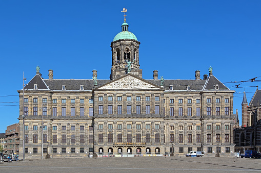 Amsterdam, Netherlands - May 27, 2013: Royal Palace on the Dam Square. The palace was built as a Town Hall in 1648-1655 by design of the Dutch artist and architect Jacob van Campen. It was converted into a Royal Palace in 1808.