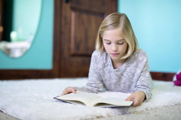 istock Blonde girl reading on floor 846499732