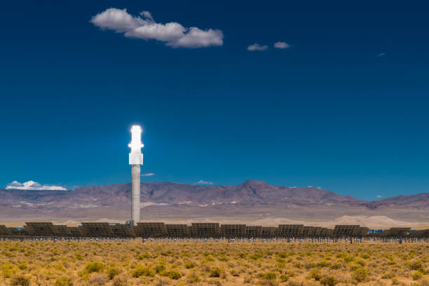 Alternative Energy Solar Thermal Power Station Illuminated bright shining tower of solar thermal power station with surrounding solar mirrors in the desert. Solar thermal power station. Nevada, USA. heliostat photos stock pictures, royalty-free photos & images