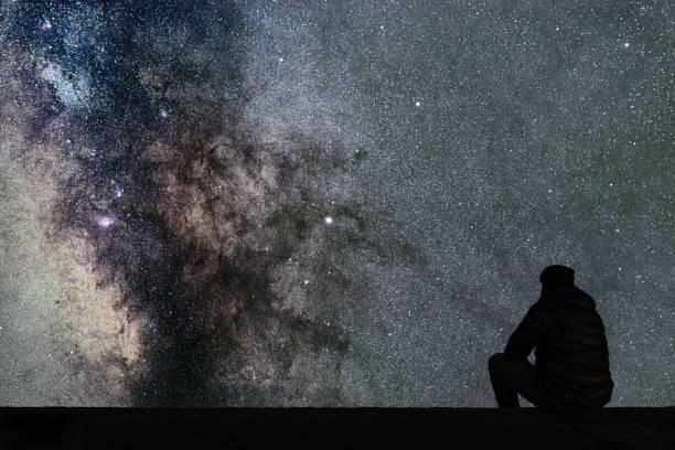istock Milky Way. Night sky with stars and silhouette alone man looking at starry sky. 846517400