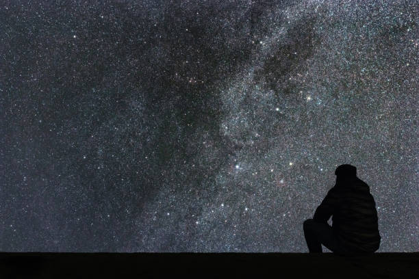 istock Milky Way. Night sky with stars and silhouette alone man looking at starry sky. 846518330
