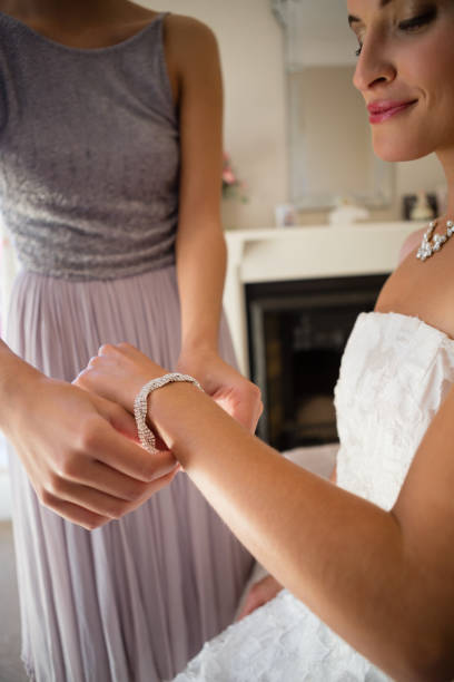 istock Midsection of bridesmaid assisting bride in getting dressed 846518624