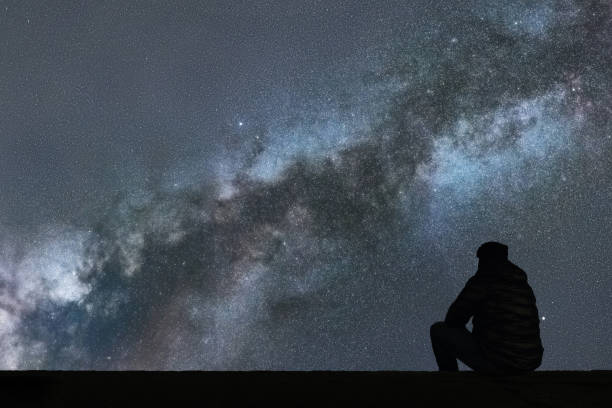 istock Milky Way. Night sky with stars and silhouette alone man looking at starry sky. 846518918