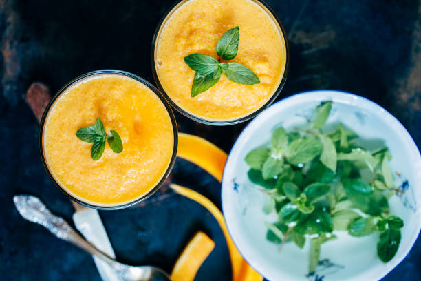 istock Orange smoothie with leaves of fresh mint 846528530