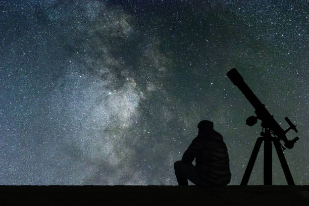 istock Man looking at the stars, astronomy telescope. Milky Way starry sky 846529072