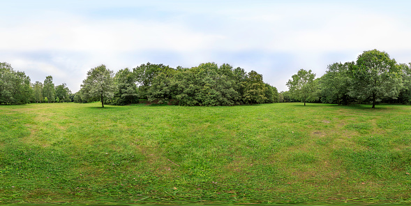 360 degrees spherical panoramic shot of green park in the summer afternoon