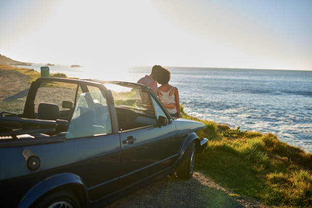 istock Young couple sitting in their car during roadtrip 846540086