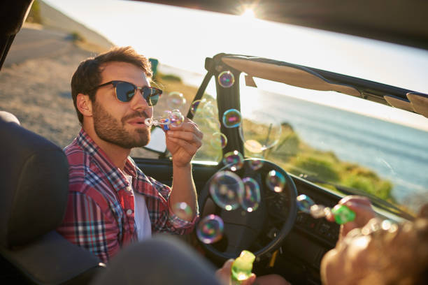 istock Young couple having fun with bubbles during roadtrip 846540158