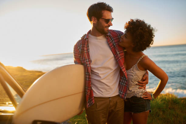 istock Young couple enjoying the views during roadtrip with their surfboard 846542532