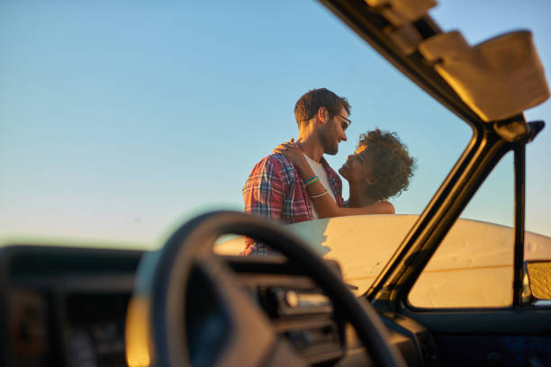 istock Young couple enjoying the views during roadtrip with their surfboard 846542578