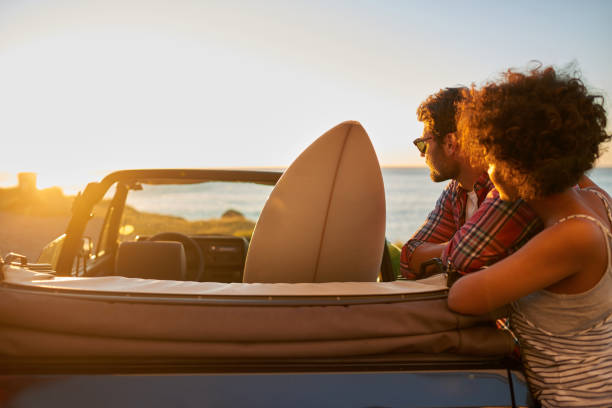 istock Young couple enjoying the views during roadtrip with their surfboard 846542622