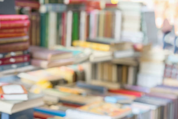 istock Blurred abstract books, textbooks, fiction in rows lying on table, on shelves in library, in modern urban bookshop. Self-study, educational, school, study concept 846543274