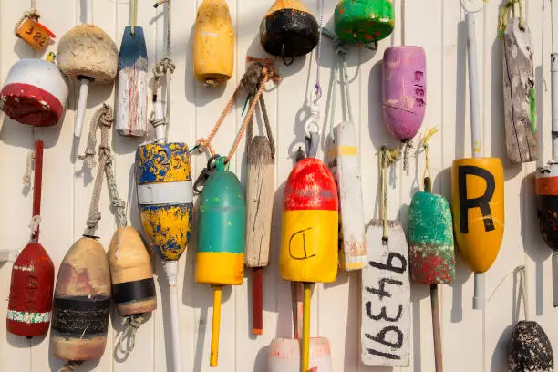 Photo of colorful lobster buoys on the wall of the house